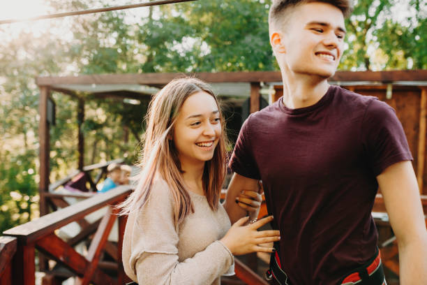 istock Laughing couple in green park looking away 1005495962