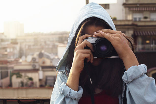 istock young girl making a photo with a vintage camera 1005496398
