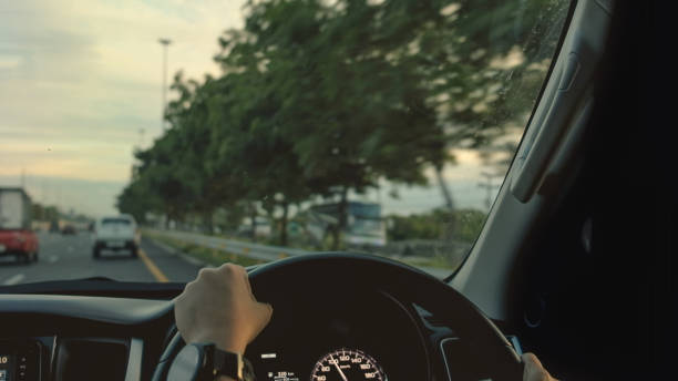 istock Driving a modern car on the road. 1005505200