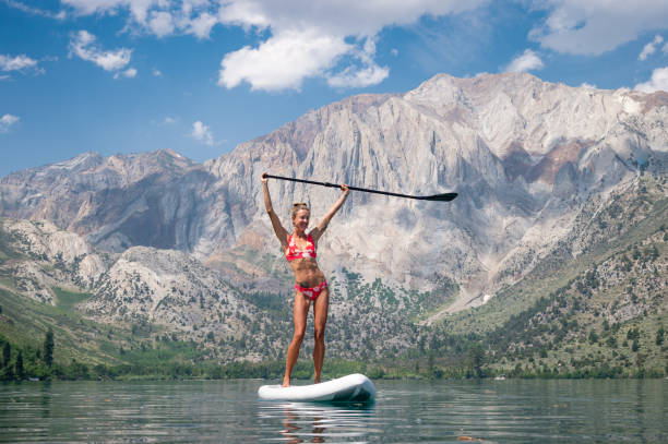 istock Woman Paddle Boarding In The Mountains 1005507970