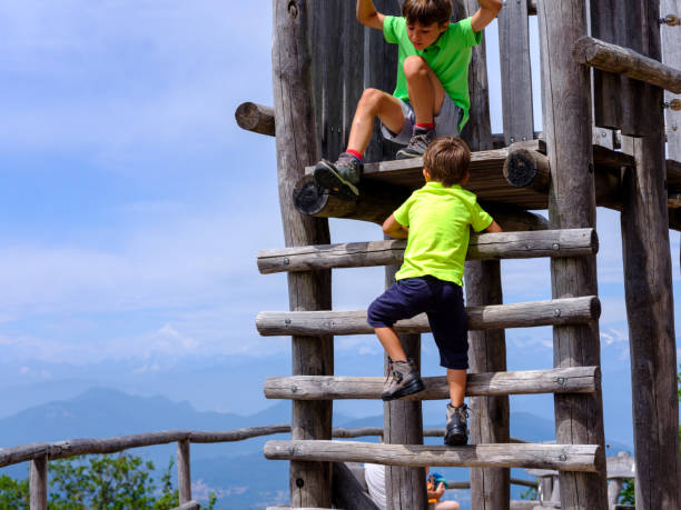 Child in the adventure park on a rope bridge