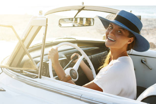 istock Beautiful woman in blue hat and white retro cabriolet 1005516340