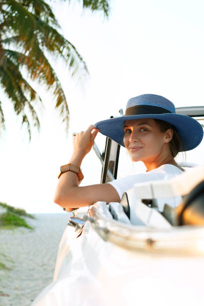 istock Beautiful woman in blue hat and white retro cabriolet 1005516434