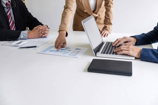 istock Teamwork process, Business team managers colleagues discussing and analysis new project investment plan, strategy in business profit, marketing documents report on table with laptop and tablet 1005516968