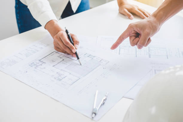 istock Architect or Engineer meeting working with partner on blueprint for architectural project in progress, construction and structure concept 1005517096