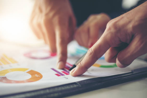 istock businessmen working and point on graph financial diagram and analysis documents on office table 1005517546