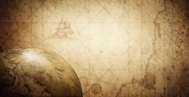 Photo of Ancient old globe on the vintage map background.