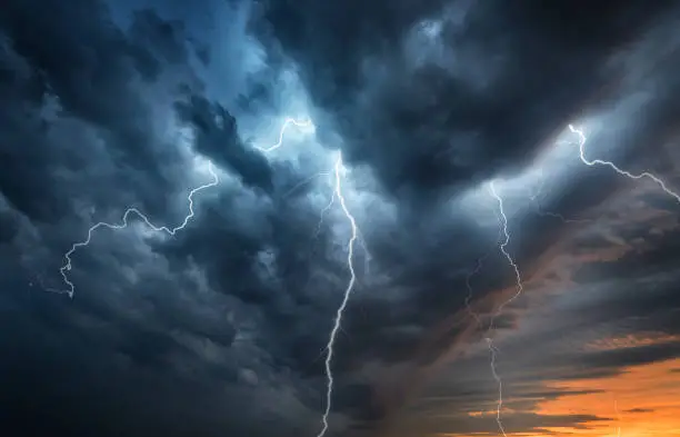 Photo of Lightning thunderstorm flash over the night sky.