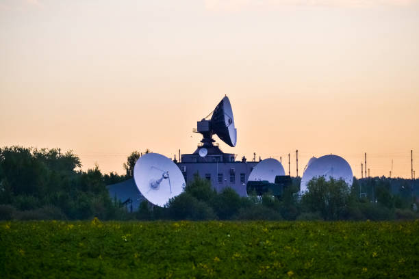 istock Several large satellite communications antennas in the field in the early morning. Space Communication Center 1005529370
