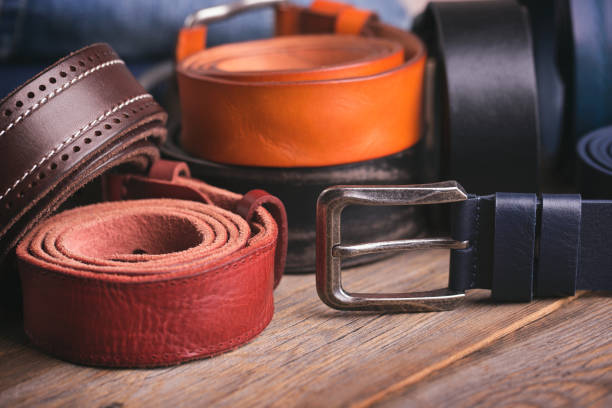 istock Leather colored belts on a wooden table 1005529734