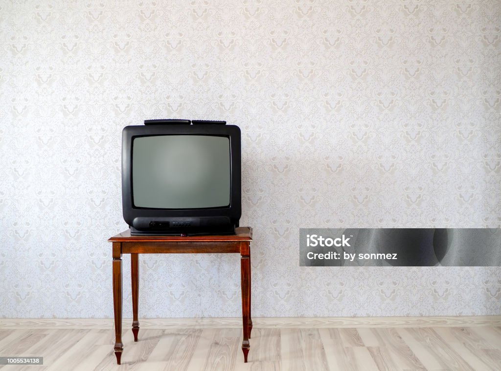 In the empty room, the old tube TV on the coffee table Television Set Stock Photo