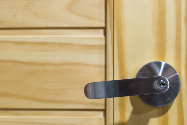 istock Door handle knob on pine wood door 1005534848