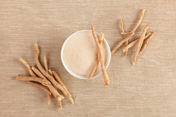 Ashwagandha root and powder supplement, top view.