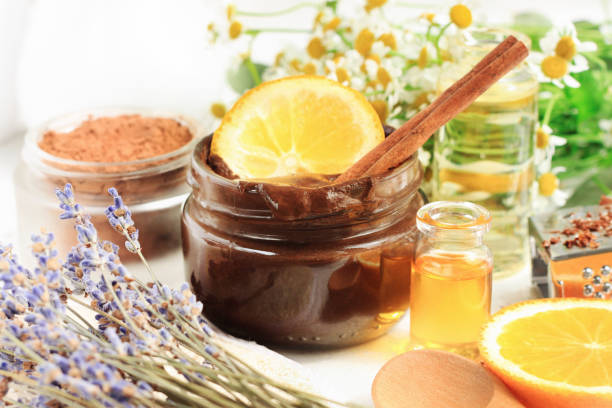 Homemade cosmetic products source of vitamins for skincare and beauty treatment. Jar of chocolate face mask with aroma orange oil and lavender blossom. natural condition stock pictures, royalty-free photos & images