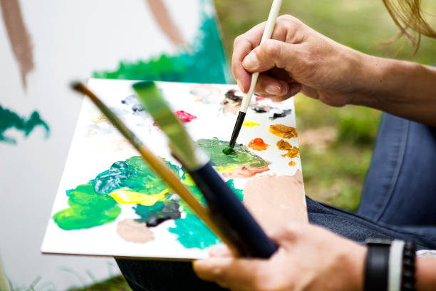 istock Young woman mixing some paint 1005549476