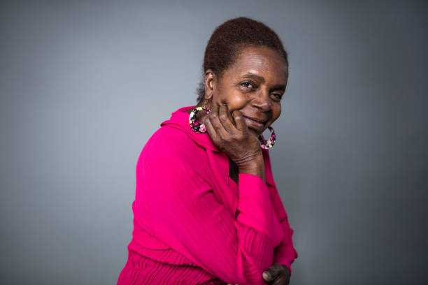 istock Smiling senior woman with hand on chin 1005549522