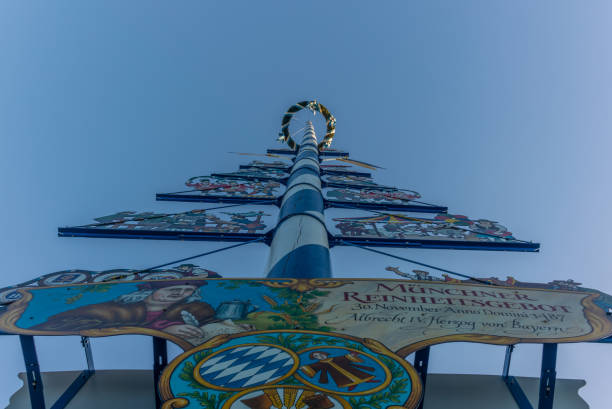 typical bavarian maypole in front of blue sky