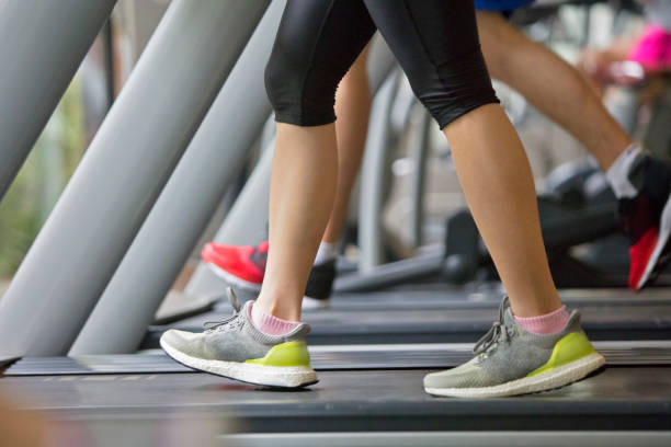 istock Female athlete jogging on treadmill 1005555880