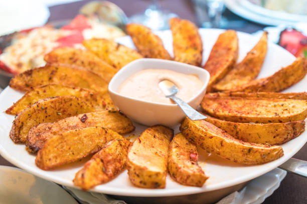 istock fried potatoes with Mexican sauce on the plate 1005574134