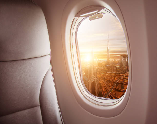 istock Airplane interior with window view of Dubai city 1005589752