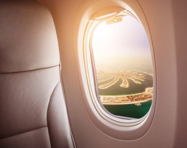 istock Airplane interior with window view of Dubai city 1005589780