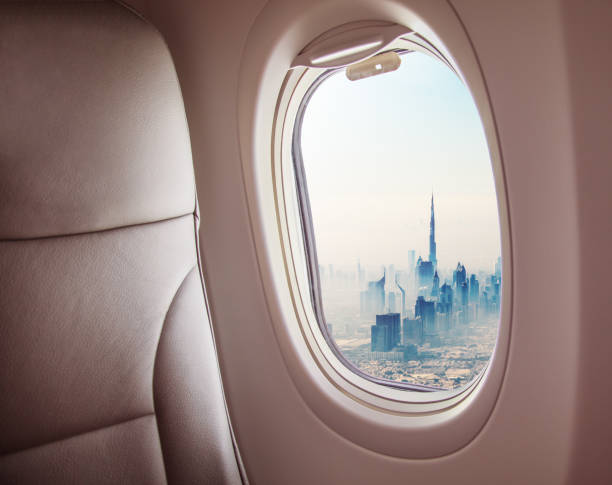 istock Airplane interior with window view of Dubai city 1005589814