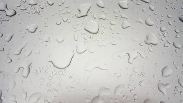istock Water Drops background on the Grey glossy surface, Rain droplets on gray texture for cosmetics, drink product. 1005589850
