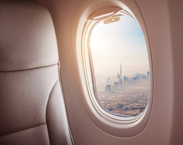 istock Airplane interior with window view of Dubai city 1005589862