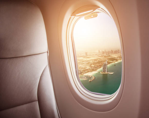 istock Airplane interior with window view of Dubai city 1005589882