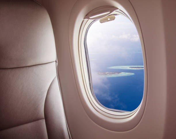 istock Airplane window with beautiful Maldives island view 1005592166