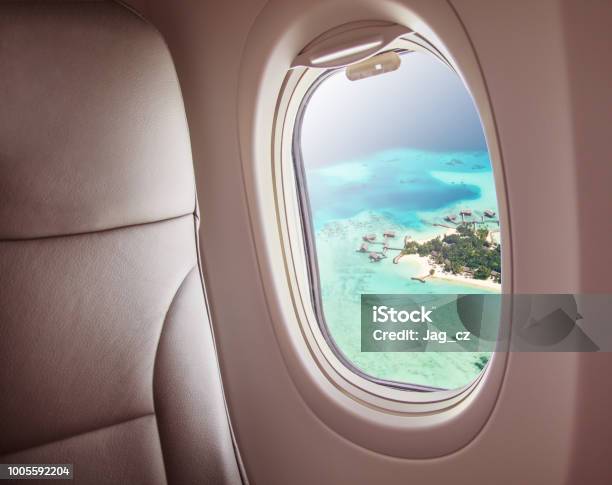 Airplane Window With Beautiful Maldives Island View Stock Photo - Download Image Now