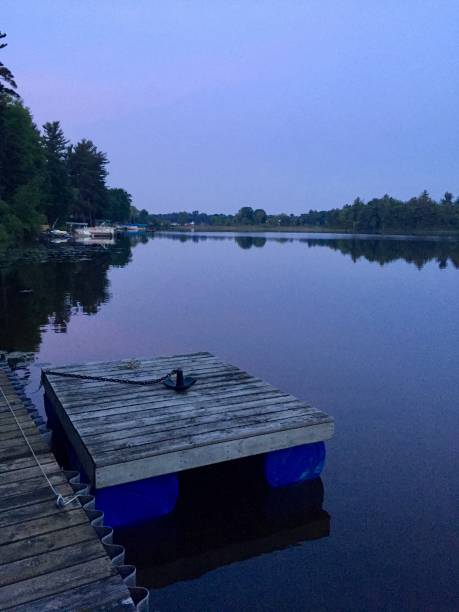 istock Standing on a dock watching the sun rise over a lake 1005592224