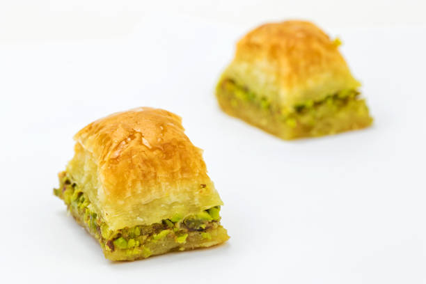 istock Baklavas with pistachios and honey on white background. 1005593294