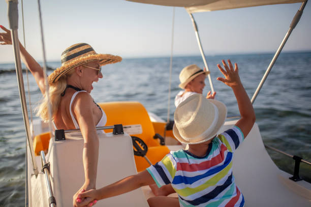 istock Mother and two sons on a pedal boat 1005593526
