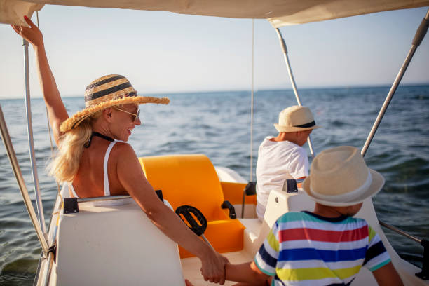 istock Mother and two sons on a pedal boat 1005593530