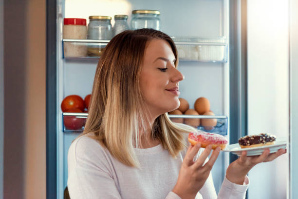 istock Woman Enjoy Eating Donuts 1005602888