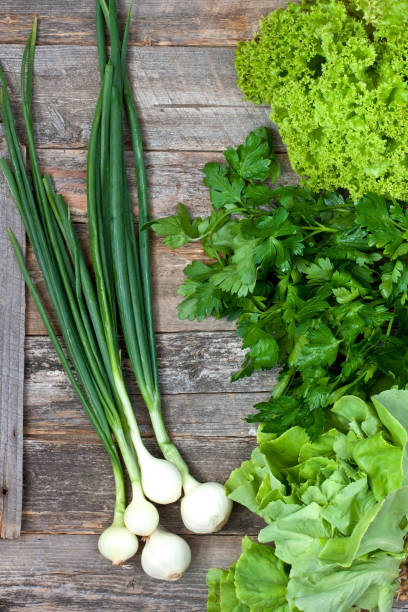 istock Green vegetables on wooden background 1005602916