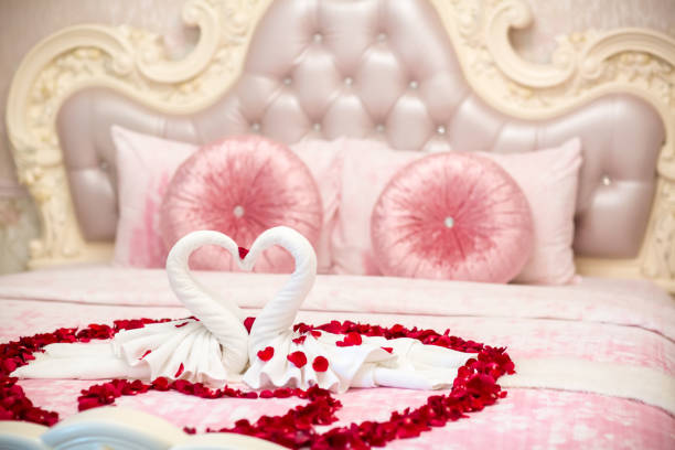 istock two towel swans shaped on the bed,Honey moon bed.Honeymoon 1005607952