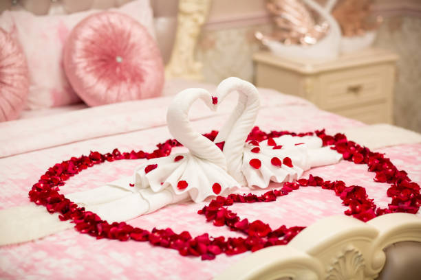 istock two towel swans shaped on the bed,Honey moon bed.Honeymoon 1005612310