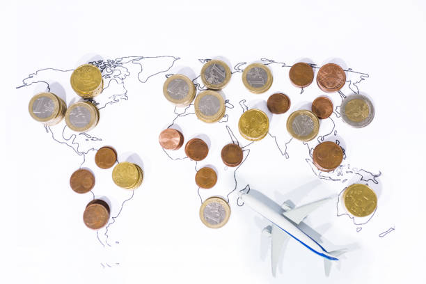 istock A lot of coins on World Map. 1005612542