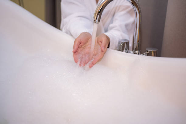 istock Young smiling and relaxing woman in bathroom. 1005612786