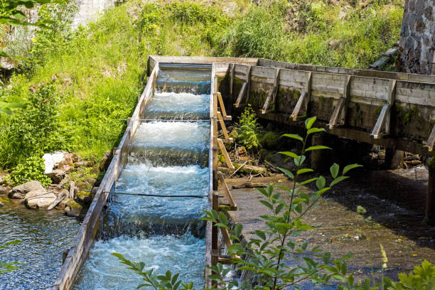 istock Water draining along the old wooden canal. 1005613088
