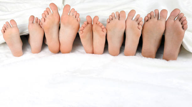 istock children's feet peeking from under the blanket 1005618538