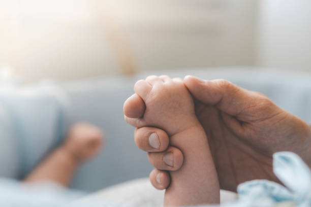 istock Baby holding his fathers hand 1005618578