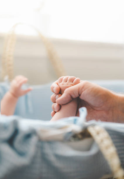 istock Baby holding his fathers hand 1005618592