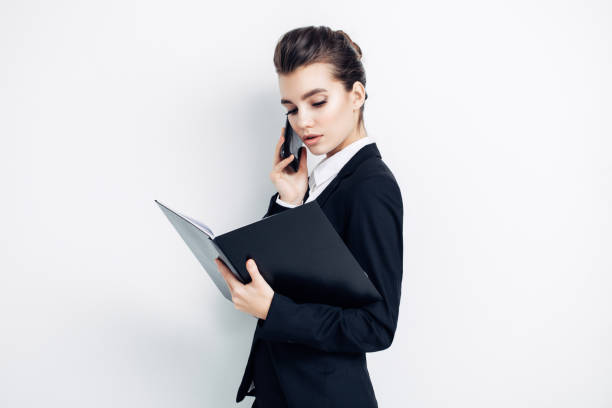 istock Woman talking on phone and reding 1005621414