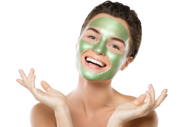 istock Woman with green peel-off mask on her face 1005624970
