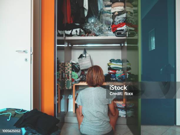 Woman Looking At Wardrobe Home Interior Desperate Housewife Cleaning Home Rear View Sitting Toned Vintage Style Stock Photo - Download Image Now