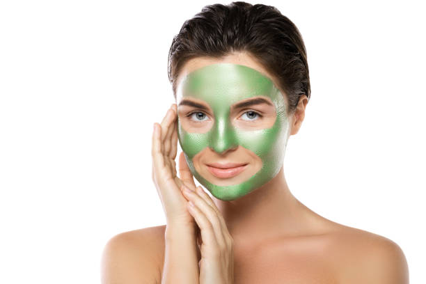 istock Woman with green peel-off mask on her face 1005625112
