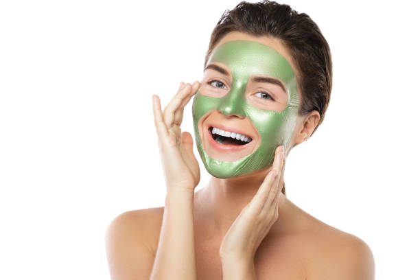 istock Woman with green peel-off mask on her face 1005627522